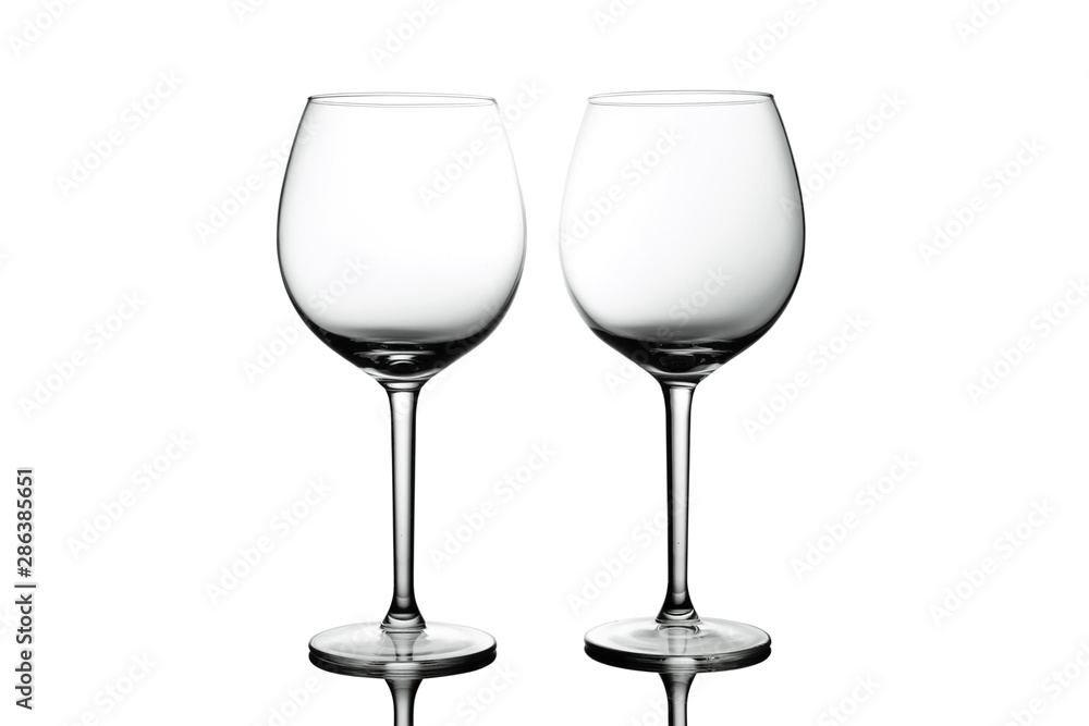 Clean Empty wine glasses with reflections on white background. Alcohol beverage card backdrop.