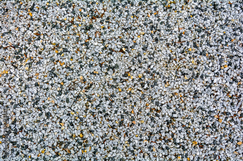 Small White pebble background. Top view of white and yellow gravel stone texture