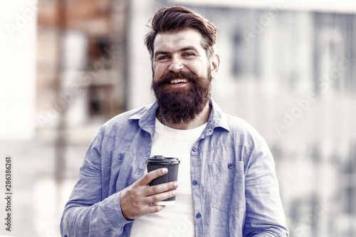 Make yourself useful. Man drink take away coffee. Bearded man relax outdoors. Coffee break concept. Caffeine addicted. Morning coffee. Mature hipster enjoy hot beverage. Coffee completes me