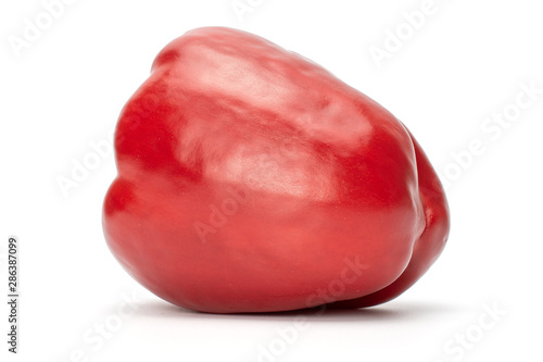 One whole red bell pepper isolated on white background