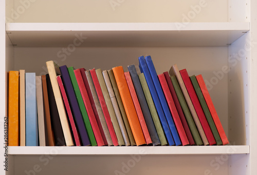 Modern white bookshelf with old books