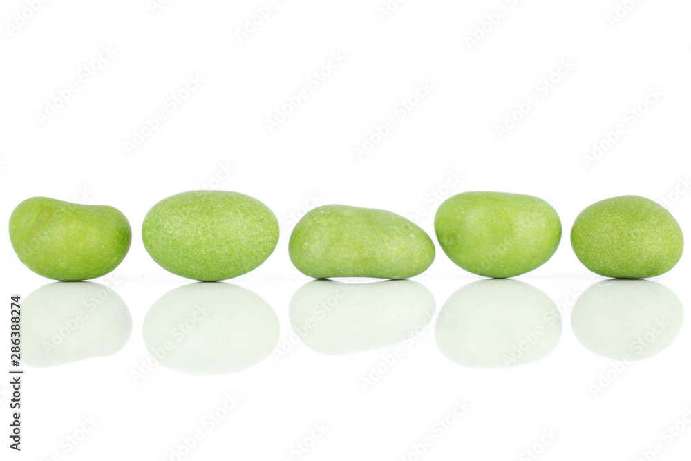 Group of five whole green sugared nut dragee isolated on white background Group of five whole green sugared nut dragee isolated on white background