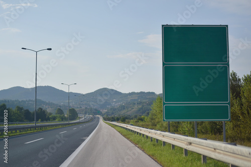 Highway and  road signs at cloudy day.