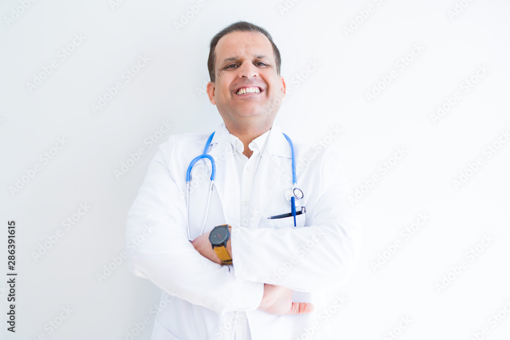 Middle age doctor man wearing stethoscope and medical coat over white background happy face smiling with crossed arms looking at the camera. Positive person. Middle age doctor man wearing stethoscope and medical coat over white background happy face smiling with crossed arms looking at the camera. Positive person.