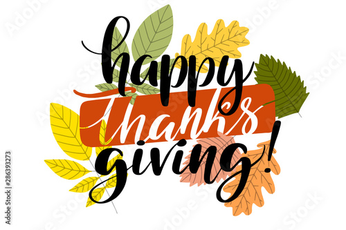 Happy thanksgiving hand written words with autumn leaves.