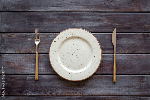 White plates and tableware for table setting on wooden background top view
