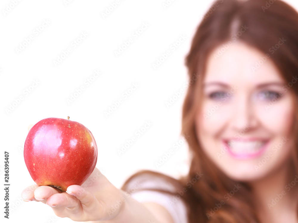 Woman holds red apple, focus on fruit Woman holds red apple, focus on fruit
