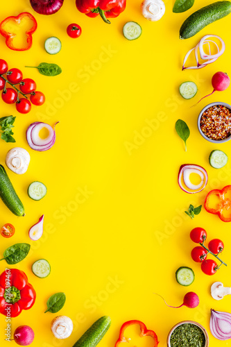 Fototapeta Naklejka Na Ścianę i Meble -  Sliced, cut, chopped vegetables frame on yellow background top view copyspace