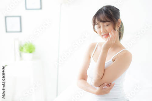 Beautiful portrait asian woman makeup of cosmetic, girl hand touch cheek and smile attractive, face beauty perfect with wellness in the bedroom with skin care and healthcare concept. Free Download Beautiful portrait asian woman makeup of cosmetic, girl hand touch cheek and smile attractive, face beauty perfect with wellness in the bedroom with skin care and healthcare concept. - GFXLoad