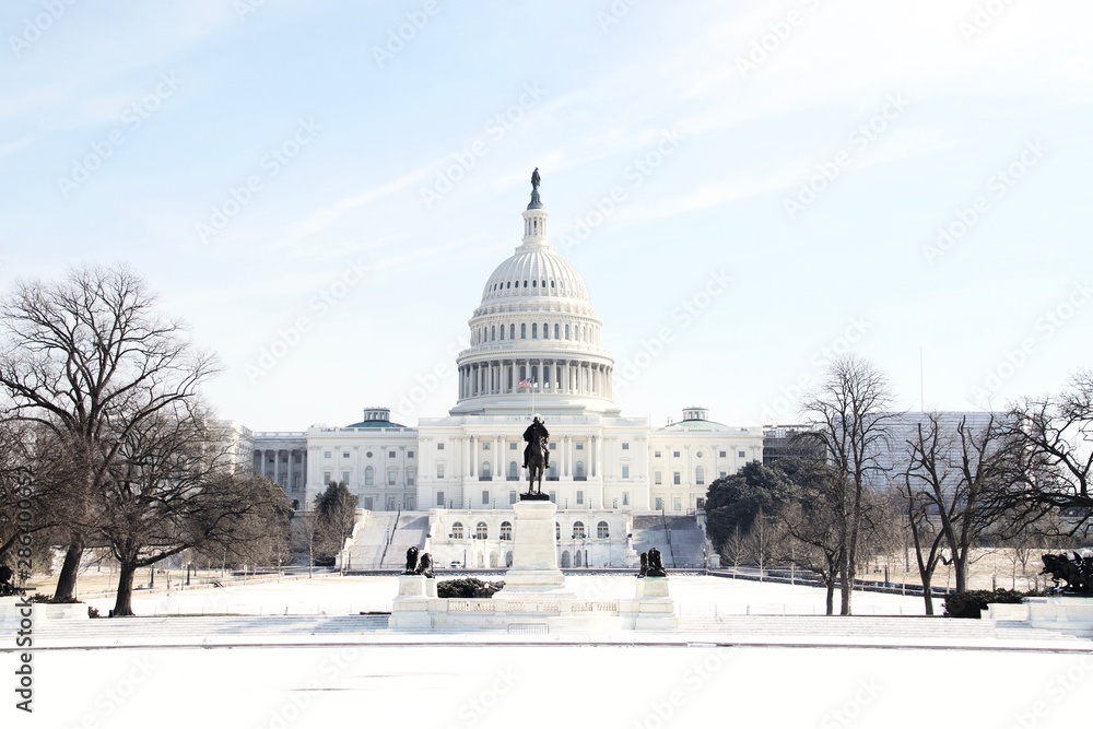 The US Capitol Building in Washington DC on a sunny winter day after a heavy snow with no people.