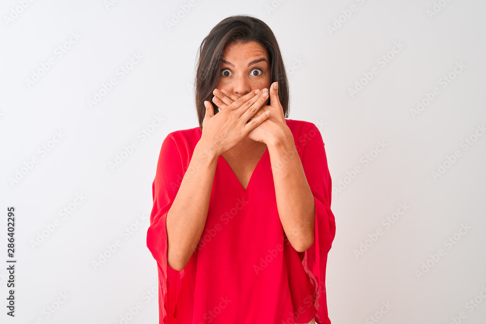 Young beautiful woman wearing red t-shirt standing over isolated white background shocked covering mouth with hands for mistake. Secret concept. Young beautiful woman wearing red t-shirt standing over isolated white background shocked covering mouth with hands for mistake. Secret concept.