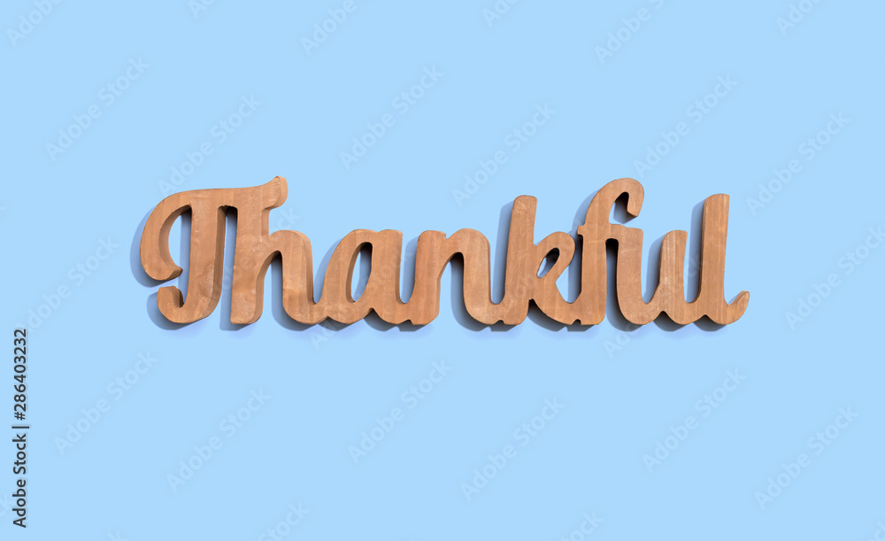 Fototapeta premium Thankful wooden text from above - overhead view