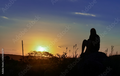 Girl contemplating the sunset. © Joel