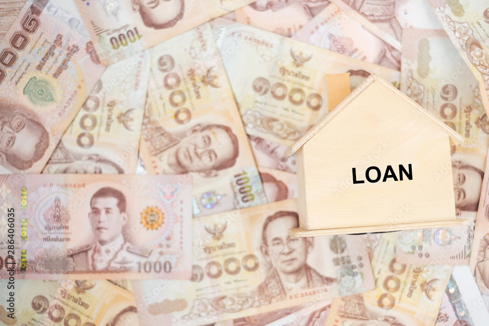 Wood house model, calculator and money , Thai baht banknote. real estate, Property investment, home mortgage financial and savings concepts Wood house model, calculator and money , Thai baht banknote. real estate, Property investment, home mortgage financial and savings concepts