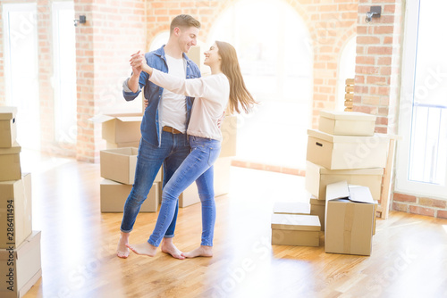 Beautiful young couple having fun dancing at new apartment, celebrating moving to a new home © Krakenimages.com