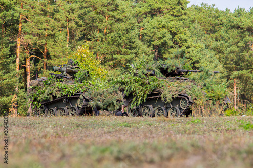 Armoured weapons carrier from german army stands at military training area photo