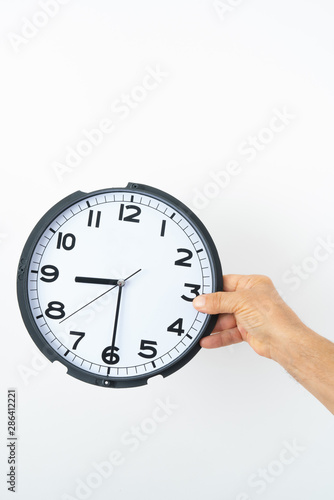 man hand holding clock