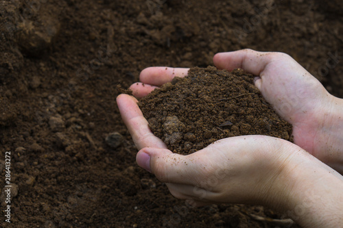 Two hands were holding soil for prepare planting.Symbol of spring and ecology concept
