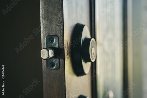 Deadbolt on wooden door engaged with bolt extended