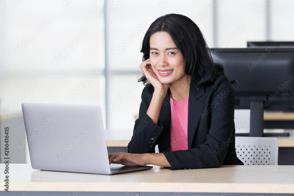 Asian businesswoman using notebook computer.. Asian businesswoman using notebook computer..
