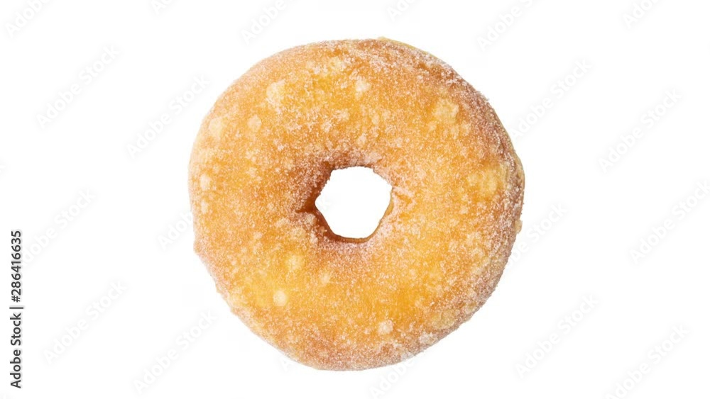 Top view of sugar springkles donut rotating on a white background Top view of sugar springkles donut rotating on a white background