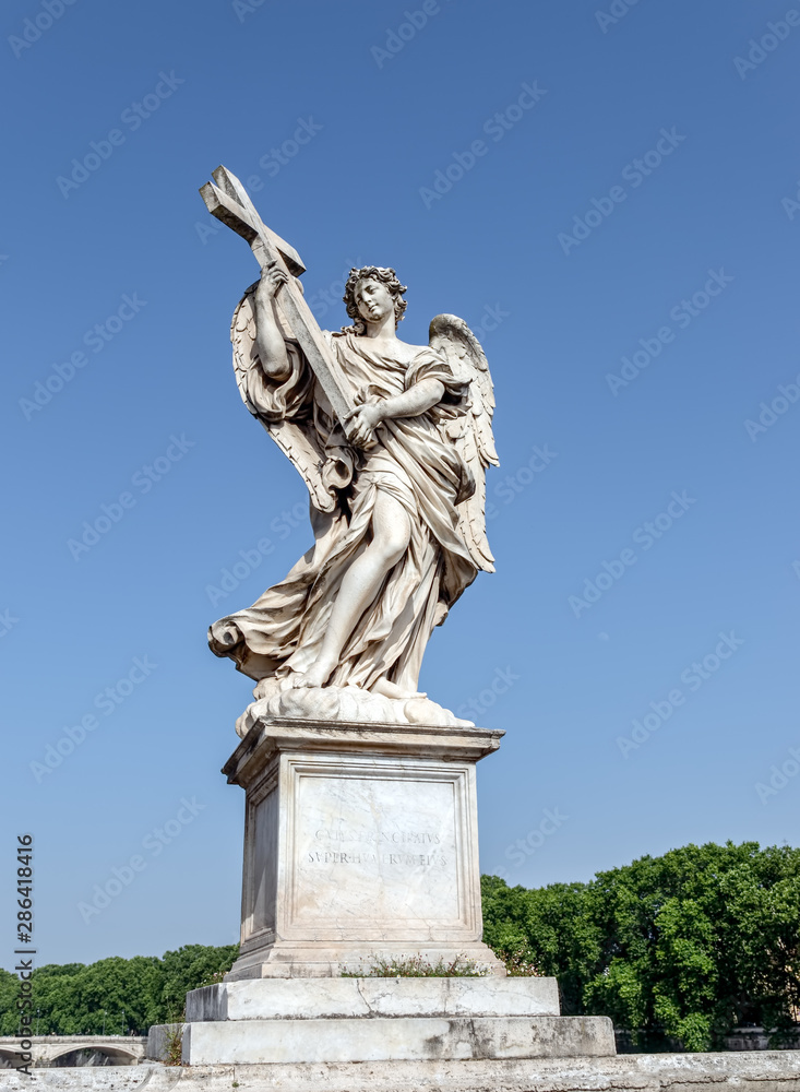 Angel with the Cross at the Sant'Angelo bridge - Rome, Italy. Sculpture by Ercole Ferrata, 1610-1686. It has the inscription Whose government shall be upon His shoulder.