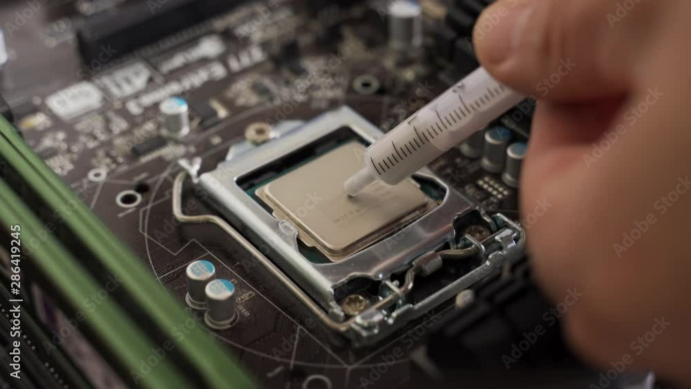 Application of thermal paste from a syringe. applying thermal paste to thecessor Application of thermal paste from a syringe. applying thermal paste to thecessor