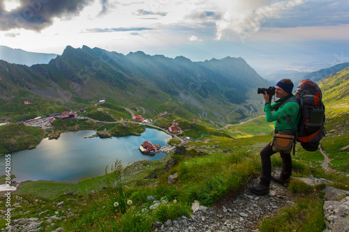 man with backpack on the mountain. photographer taking photos. Balea, Romania © Ioan Panaite