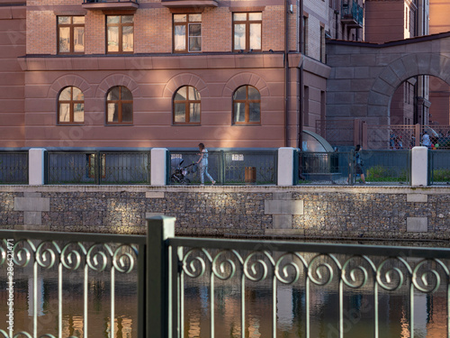 Russia residential complex in the City of Naberezhnye Houses by the river lit by the sun Quay residential quarter by the river photo