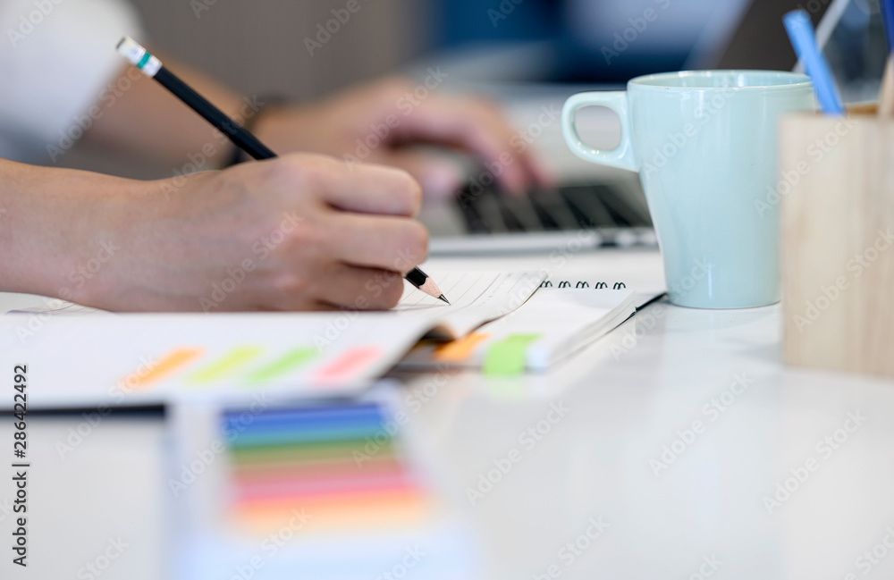 Man writing or drawing with pencil on notebook. Man writing or drawing with pencil on notebook.