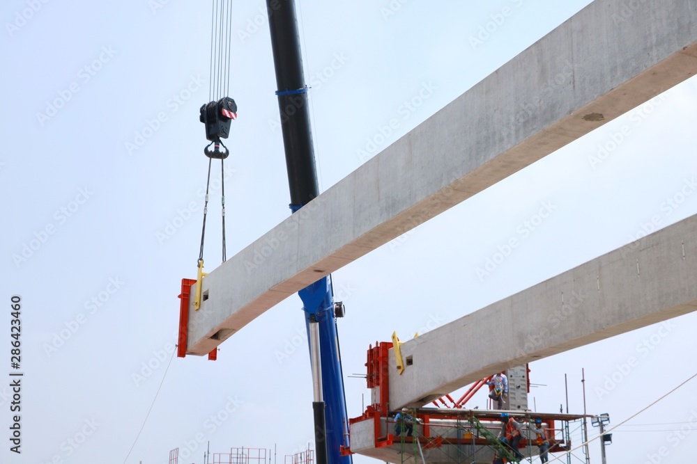 Tower crane with guideway beam on blue sky as a background in the construction site, Space for text in template, Industrial skyline Tower crane with guideway beam on blue sky as a background in the construction site, Space for text in template, Industrial skyline