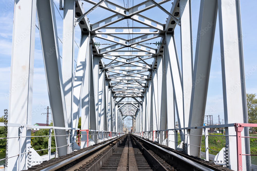 Empty long railway metallic bridge with rails. sunny day Empty long railway metallic bridge with rails. sunny day