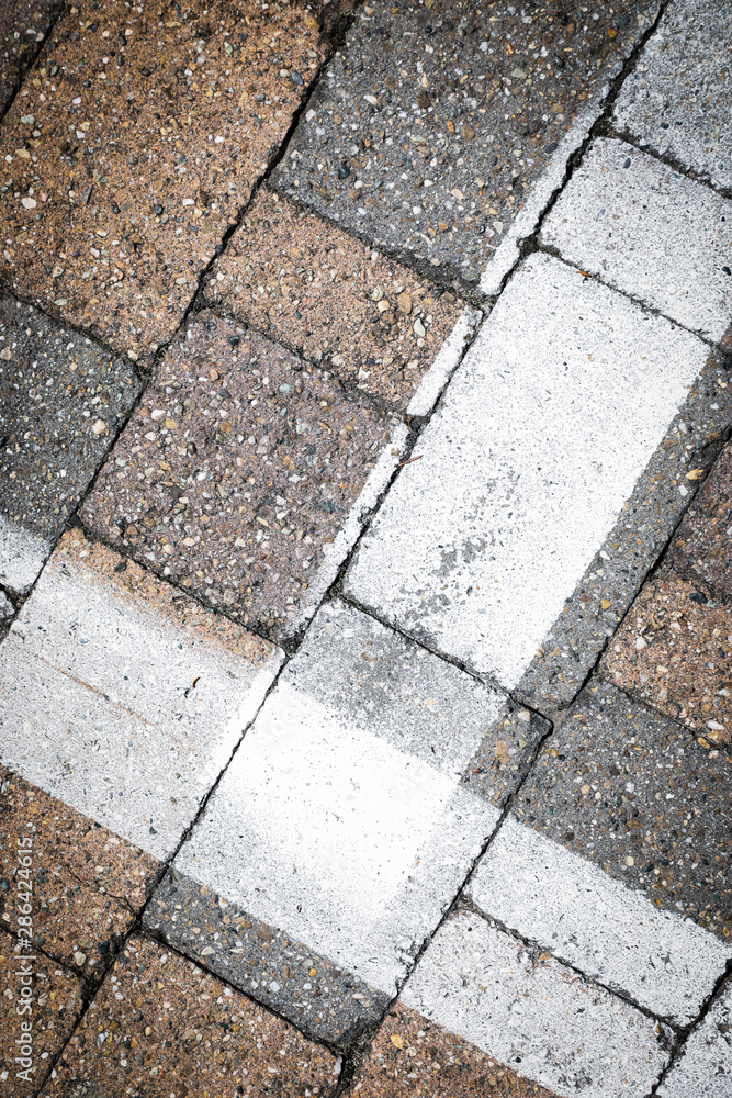 white painted road markings on a stone for a abstract background white painted road markings on a stone for a abstract background