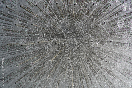 Fountain in the sun backlight. The fountains gushing sparkling water from pipe in park