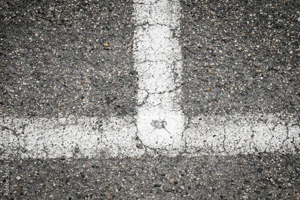Fototapeta premium white painted road markings on a gray pavement for a background