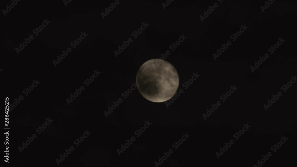 A full moon behind ominous looking clouds. A full moon behind ominous looking clouds.