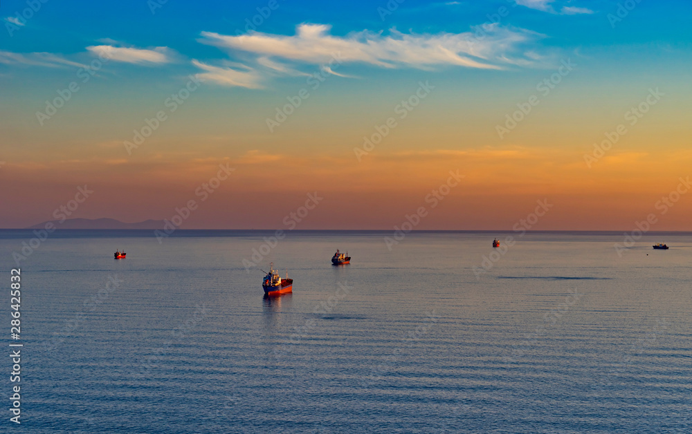 Seascape with tanker and ships on the background of the sea and coastline.