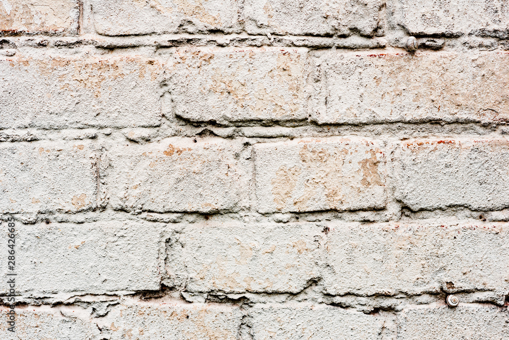 Texture of a brick wall with cracks and scratches which can be used as a background Texture of a brick wall with cracks and scratches which can be used as a background