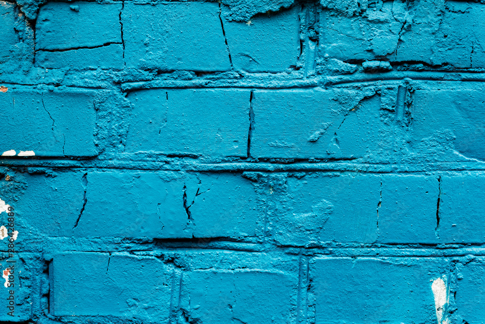 Texture of a brick wall with cracks and scratches which can be used as a background Texture of a brick wall with cracks and scratches which can be used as a background