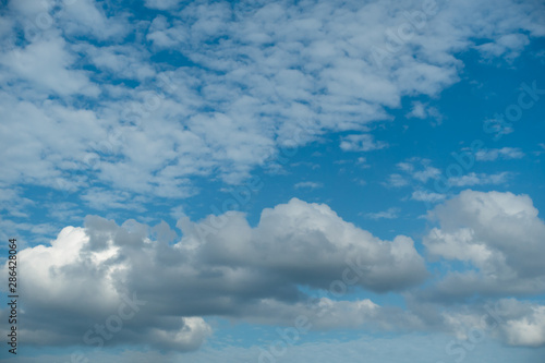 White and black clouds on a bright blue sky