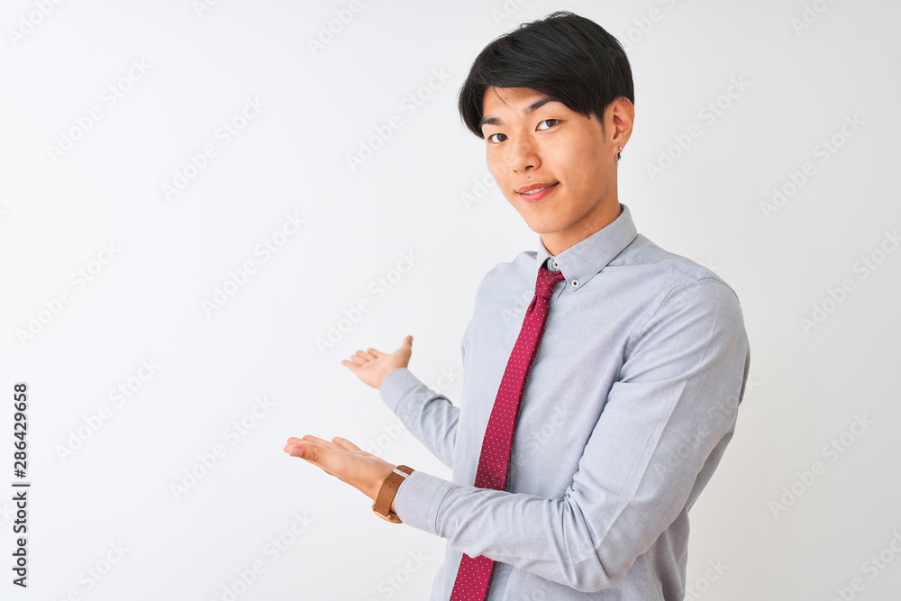 Chinese businessman wearing elegant tie standing over isolated white background Inviting to enter smiling natural with open hand Chinese businessman wearing elegant tie standing over isolated white background Inviting to enter smiling natural with open hand