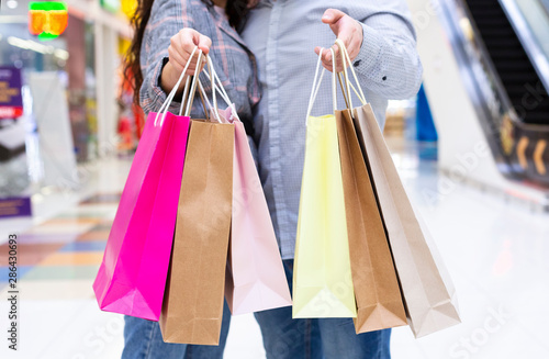 Shopping and discounts. Couple with paper bags in hands