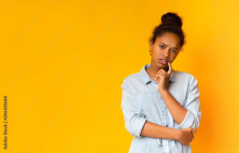 Sceptical teen looking suspiciously to camera, having some doubts Sceptical teen looking suspiciously to camera, having some doubts
