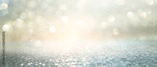 background of abstract glitter lights. silver and gold. de-focused. banner