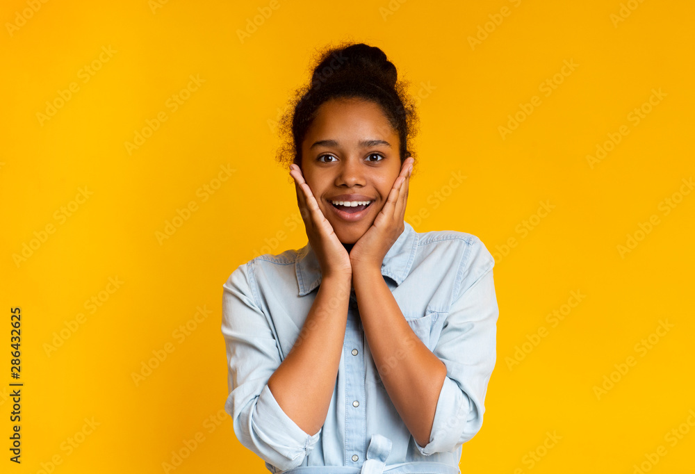 Surprised and shocked african american girl standing with opened mouth Surprised and shocked african american girl standing with opened mouth