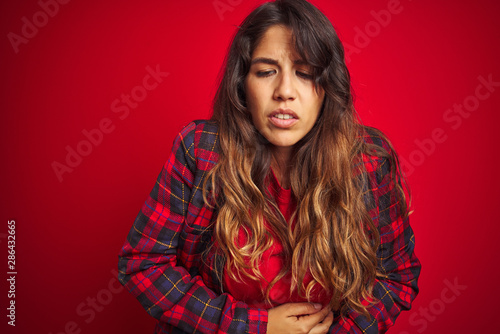 Young beautiful woman wearing casual jacket standing over red isolated background Smiling with hands palms together receiving or giving gesture. Hold and protection