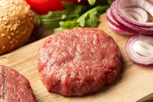 Raw ground meat burger steak cutlet  on board