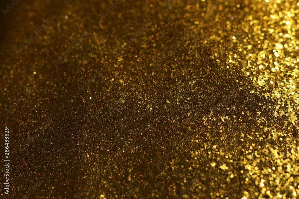 background of abstract glitter lights. gold and black. de focused