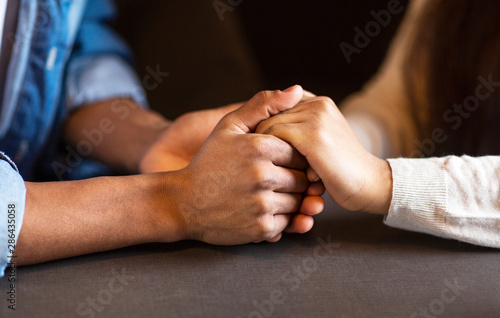 Mixed race couple in love holding hands