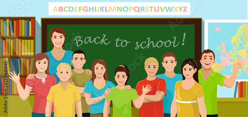 Teacher and pupils are in the schoolroom. Teacher and children stand in front of the blackboard, bookcase and map. Back to school concept. Vector illustration.
